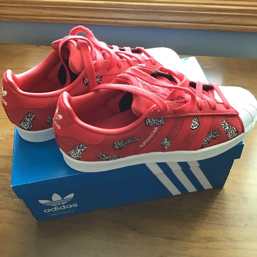 Adidas Superstar Womens shoes with pineapple graphic design.